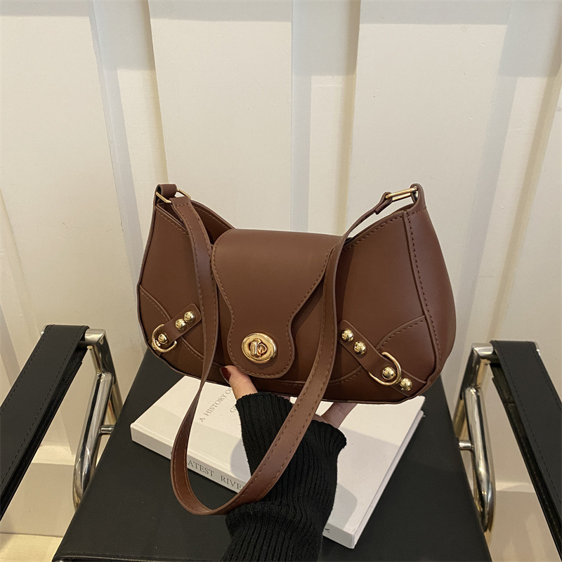 Bolsa de bolinillos retro chica caliente un hombro bolso de mochila para mujeres 2025 nuevo diseño locomotora de cierre de viento bolso de brazo