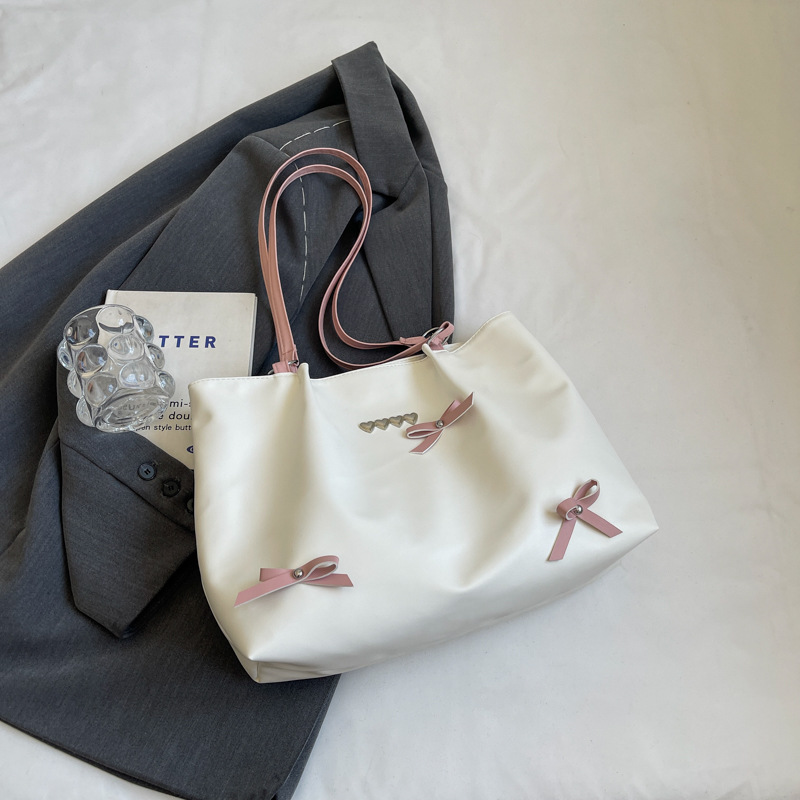 Este año popular bolso de viaje de moda coreana, bolso de hombro de estilo de ballet de mujer, textura alta, arco, bolso de mano.