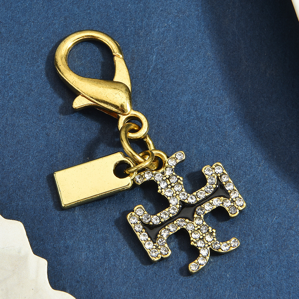 Multiple Styles of Gold Alloy Keychains with Dinosaur, Four-Leaf Clover, and Heart-Shaped Pendants, Lobster Clasp Accessories, and Exquisite Ornaments