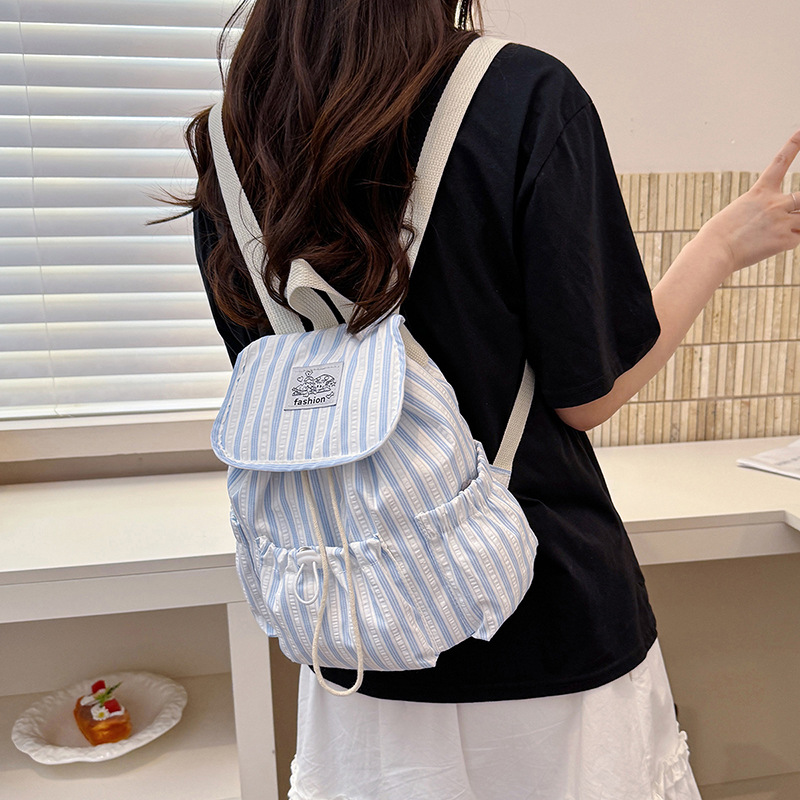 Bolsa de lona a rayas casuales de viento universitario para mujeres verano 2026 nueva mochila simple de gran capacidad mochila de estudiantes
