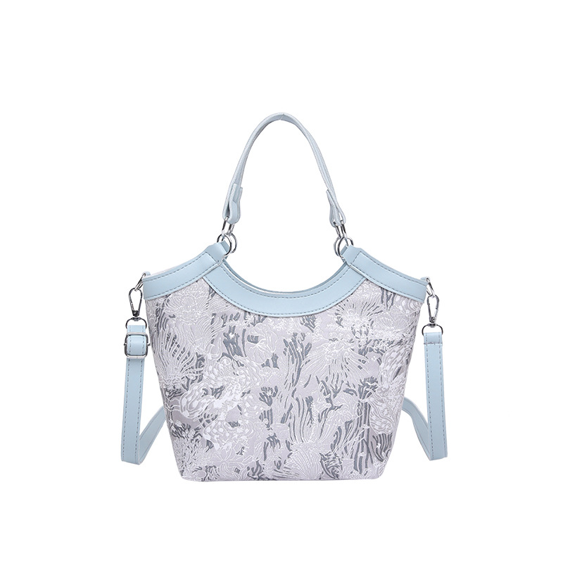 Nueva bolsa de mano de estilo chino para mujeres 2025 primavera nueva seda bordada de hombro único bolso de cubo de estilo occidental