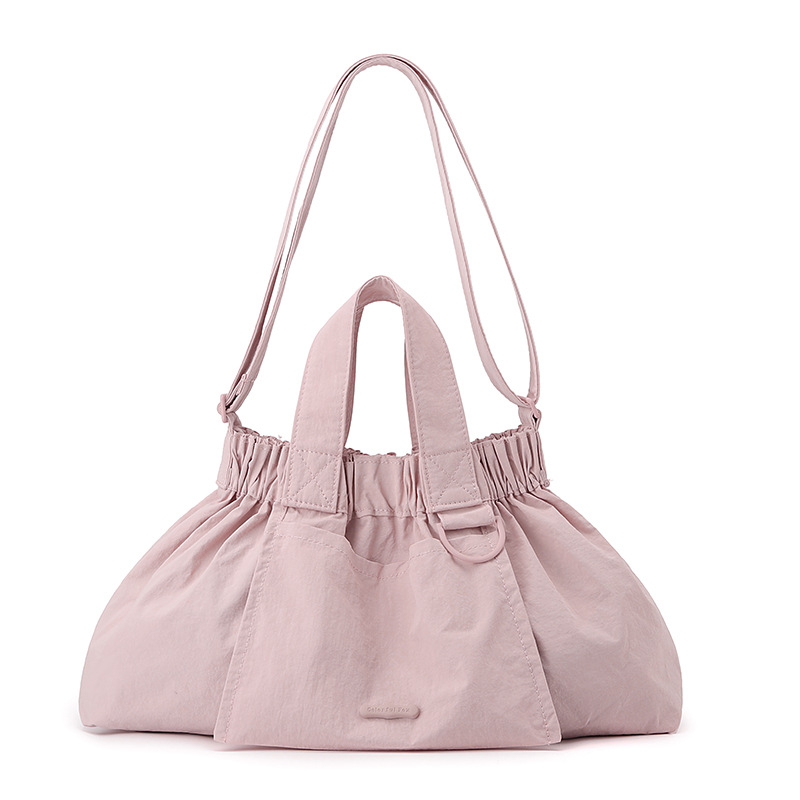 El nuevo diseño de nicho coreano del comercio exterior tiene un sentido del conocimiento de embarque a mano y una bolsa de mujer en el hombro es ligera, casual y plegable.