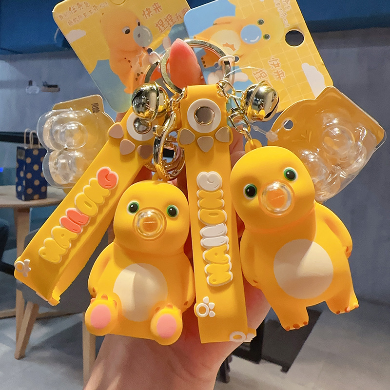 Cartoon genuine decompression twisted milk Dragon bubble keychain female cute creative personality bag ornaments wholesale