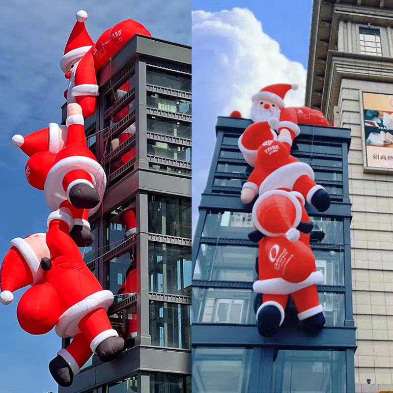 空気入れサンタクロースの空気型は壁に登って光るクリスマスツリーを飾って雪だるまの屋外のデパートの漫画の空気型を飾ってカスタマイズします。|undefined