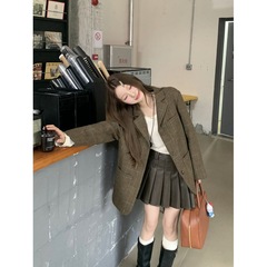小柄な格子の大きいサイズのスーツの女性のコートはゆったりしています。