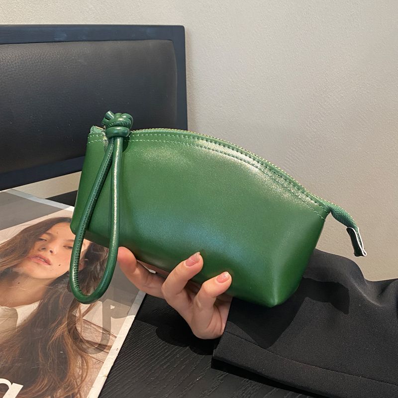 Viajes de moda primavera y verano nuevo nicho de diseño pu piel retrógrada elegante portátil bolso de bollo de gran capacidad transfronterizo para mujeres