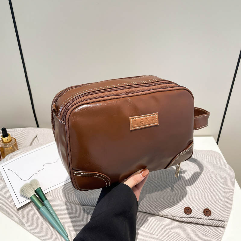 2025 nuevo paquete de lavado multicapa de gran capacidad, bolsas de maquillaje comerciales simples, bolsas de almacenamiento multifuncionales para viajes de cuero pu