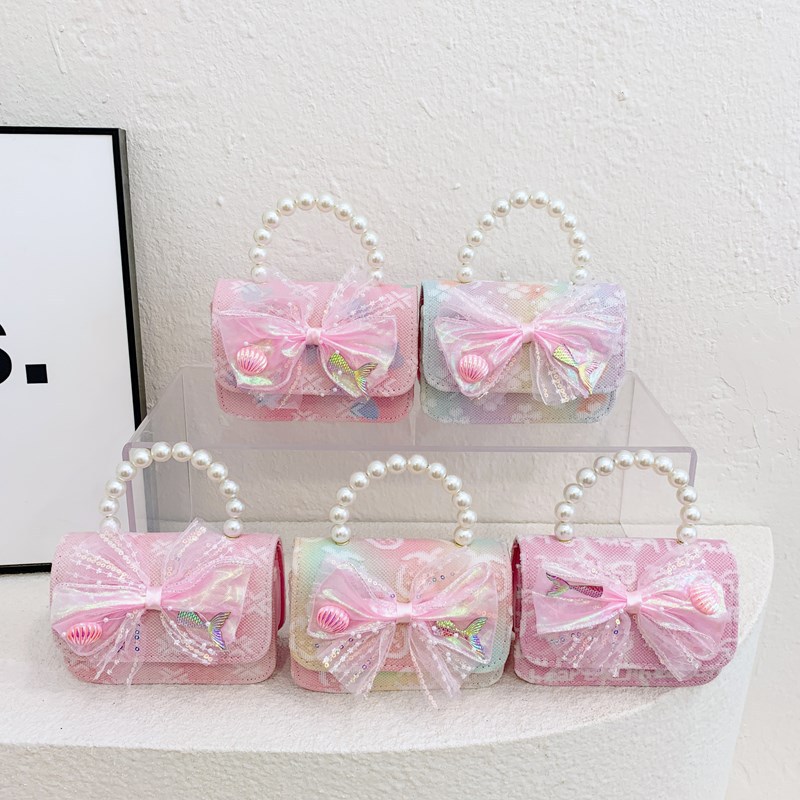 Nuevo bolso infantil dulce lindo arco bebé bolso de perla cadena de moda bolso de hombro para hombres y mujeres
