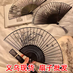 中国風の折りたたみ扇子は古風漢服の時代劇のダンスを持ち歩いています。