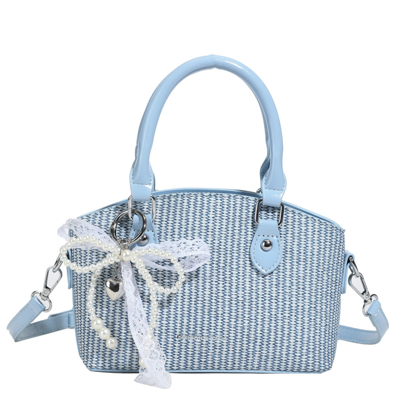 Vacaciones de verano en la playa de viajes bolsa de conchas de arena mujer 2025 este año bolsa de paja popular nueva bolsa de hombro tejida