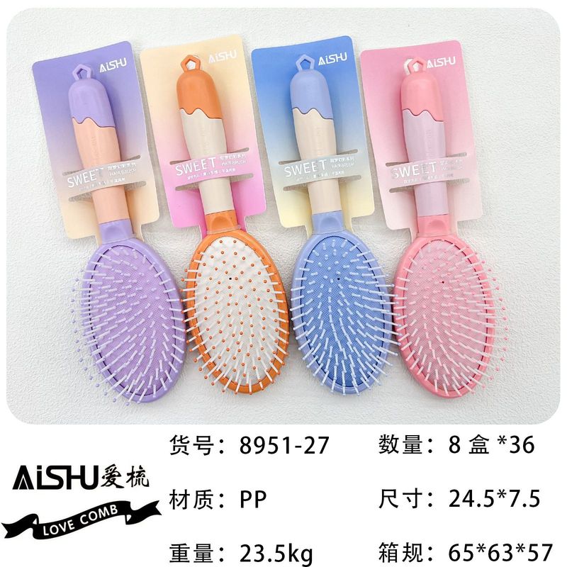 新商品のキャンディー色のクッションマッサージ櫛の半円の頭がふわふわしています。|undefined