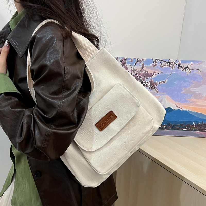 Bolsa de lona de gran capacidad para mujeres otoño-invierno 2024 nuevo estilo tideins viento brazalete bolsa de ocio estudiante bolsa de tote minimalista viento