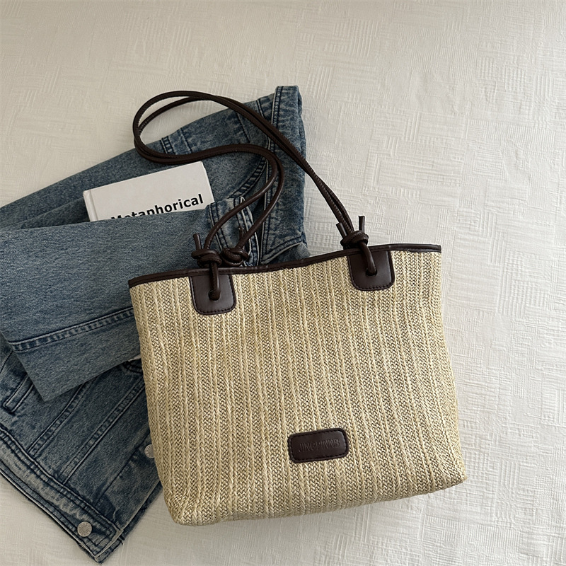 Bolsa de paja tejida para mujeres 2024 verano nuevo mochila portátil versátil bolso de balde de agua de estilo exterior bolso de trabajo