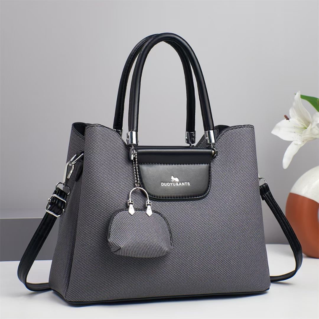 El nuevo bolso de mano para niños y madres está de moda en el bolso de hombro de textura, bolso de mensajero de diseño de nicho coreano de todo fósforo, comercio exterior