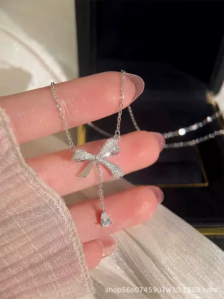 Necklace with tassels with bow drop-shaped