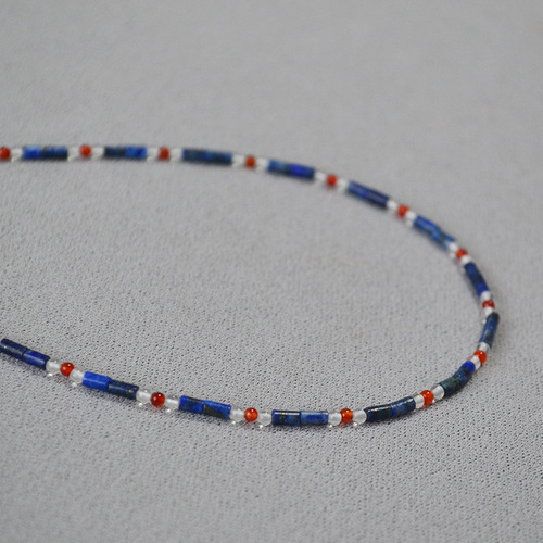 A handmade beaded necklace with new Chinese style, featuring a mix of vintage, literary, blue lapis lazuli, red agate, and genuine stones, with dot separators.