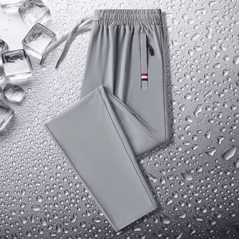 Camisas y menos ropa, pantalones de seda de hielo, pantalones de chándal elásticos finos de verano, pantalones rectos de hombre con cremallera de bolsillo al por mayor al por mayor