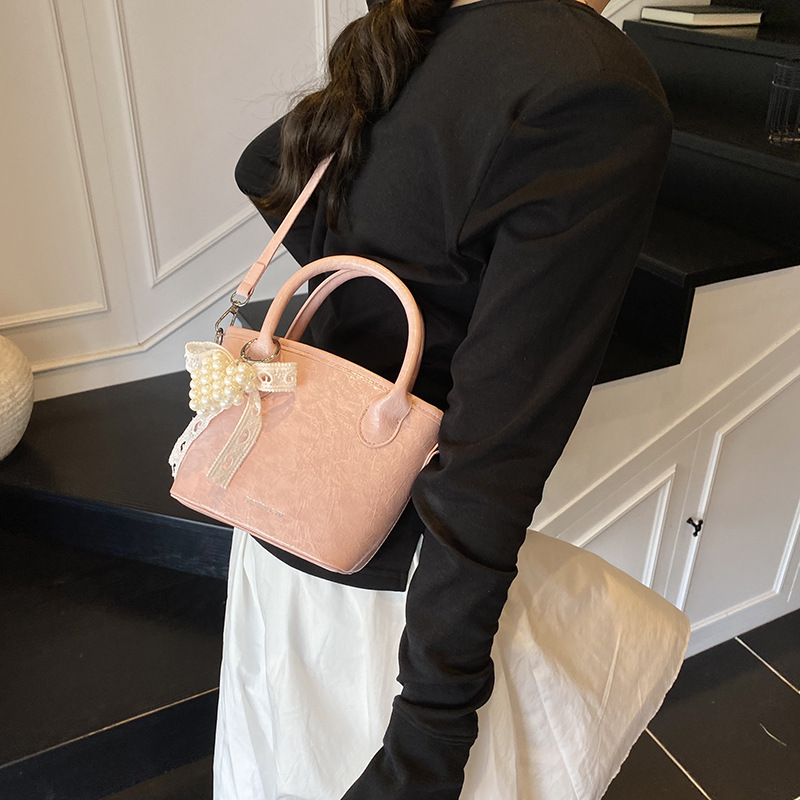 Bolso de cubo de mano súper caliente de comercio exterior 2025 nuevo bolso de hombro de tendencia salvaje de moda bolso de mensajero de nicho de alta gama de moda