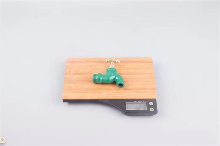 Old-fashioned iron faucet with a slow opening time of 4 minutes or 6 minutes and a fast opening time. It is a copper core flat spout cast iron faucet with a key at an outdoor construction site undefined