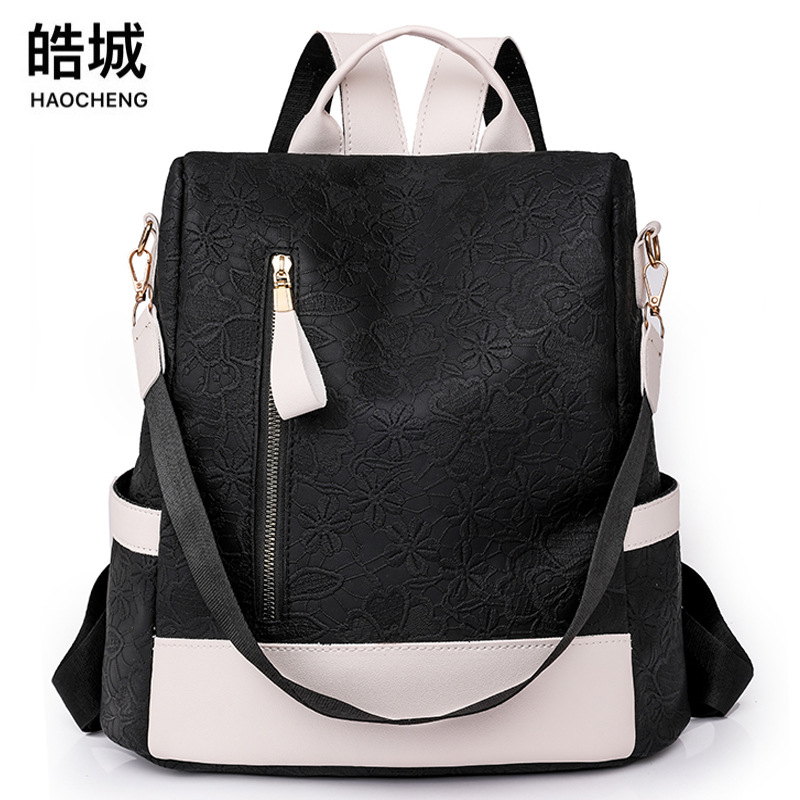 Spot al por mayor 2023 nueva mochila antirrobo de cuero suave para mujer, mochila multifuncional en relieve de color de contraste simple, mochila escolar