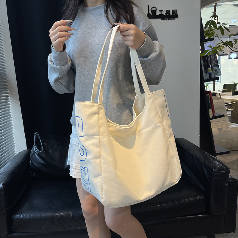 Bolso Tote de moda coreana 2025 verano nuevo estilo bolso femenino casual alfabeto bolso de hombro de lona estilo universitario