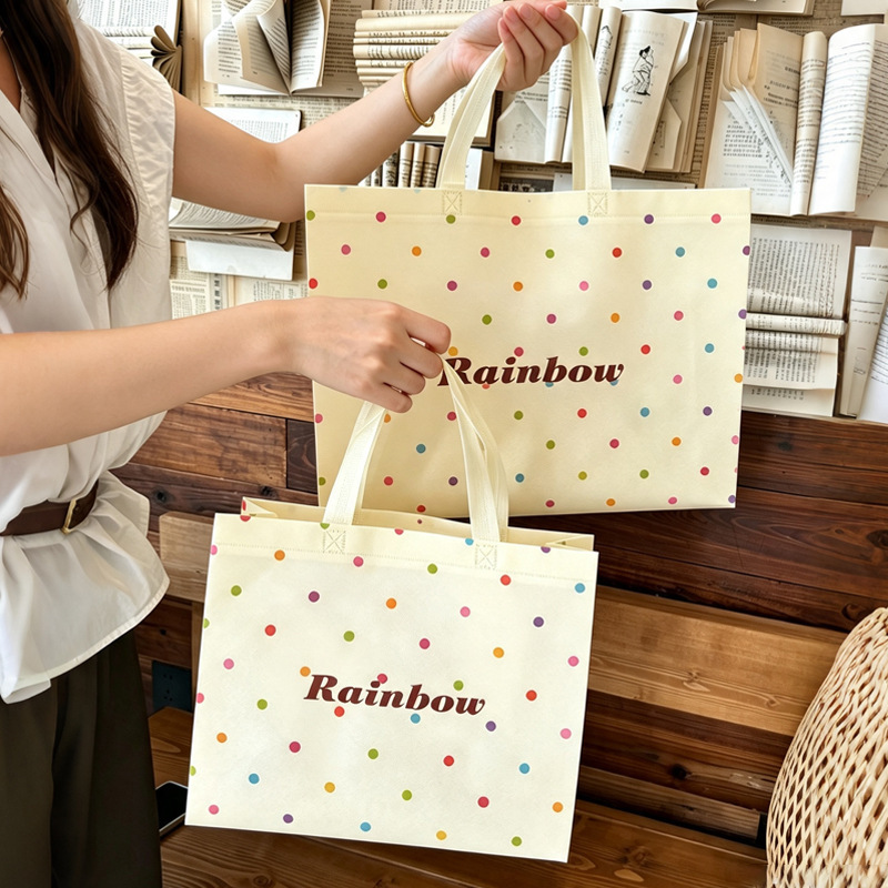 Colorful polka dot non-woven fabric clothing bags, women's clothing gift bags, available in stock, customizable with logos, wholesale for shopping and packaging Colorful polka dot non-woven fabric clothing bags, women's clothing gift bags, available in stock, customizable with logos, wholesale for shopping and packaging