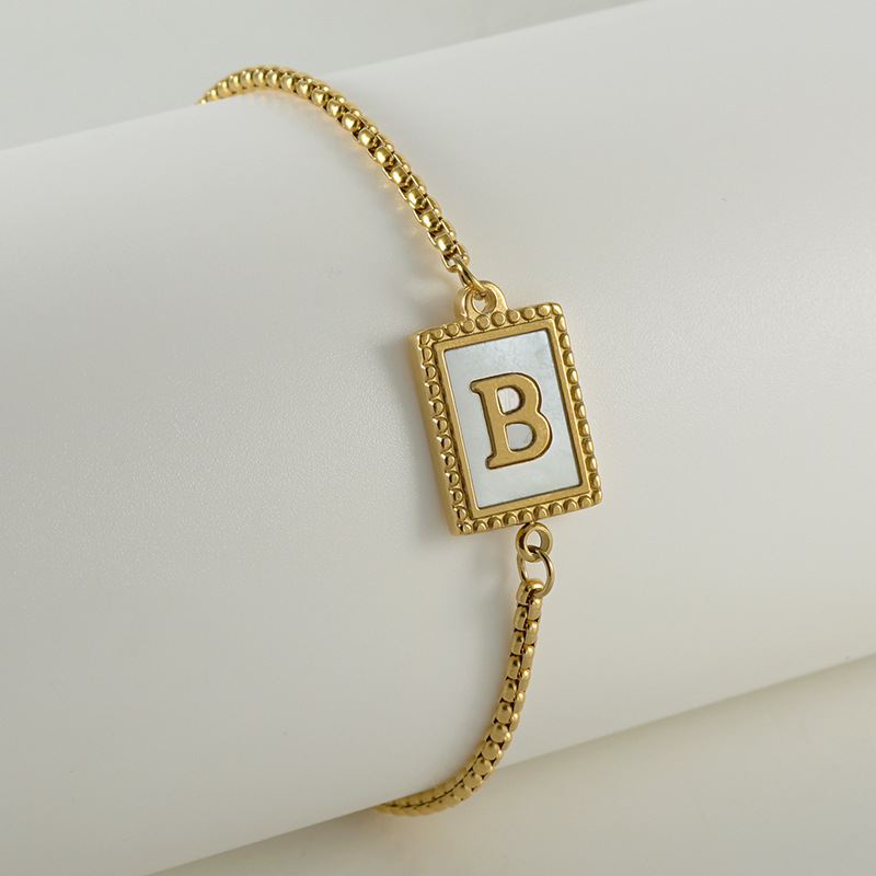 Nuevo europeo y americano transfronterizo de acero inoxidable 26 letras inglesas Shell pulsera personalidad todo partido titanio acero 18K cremallera