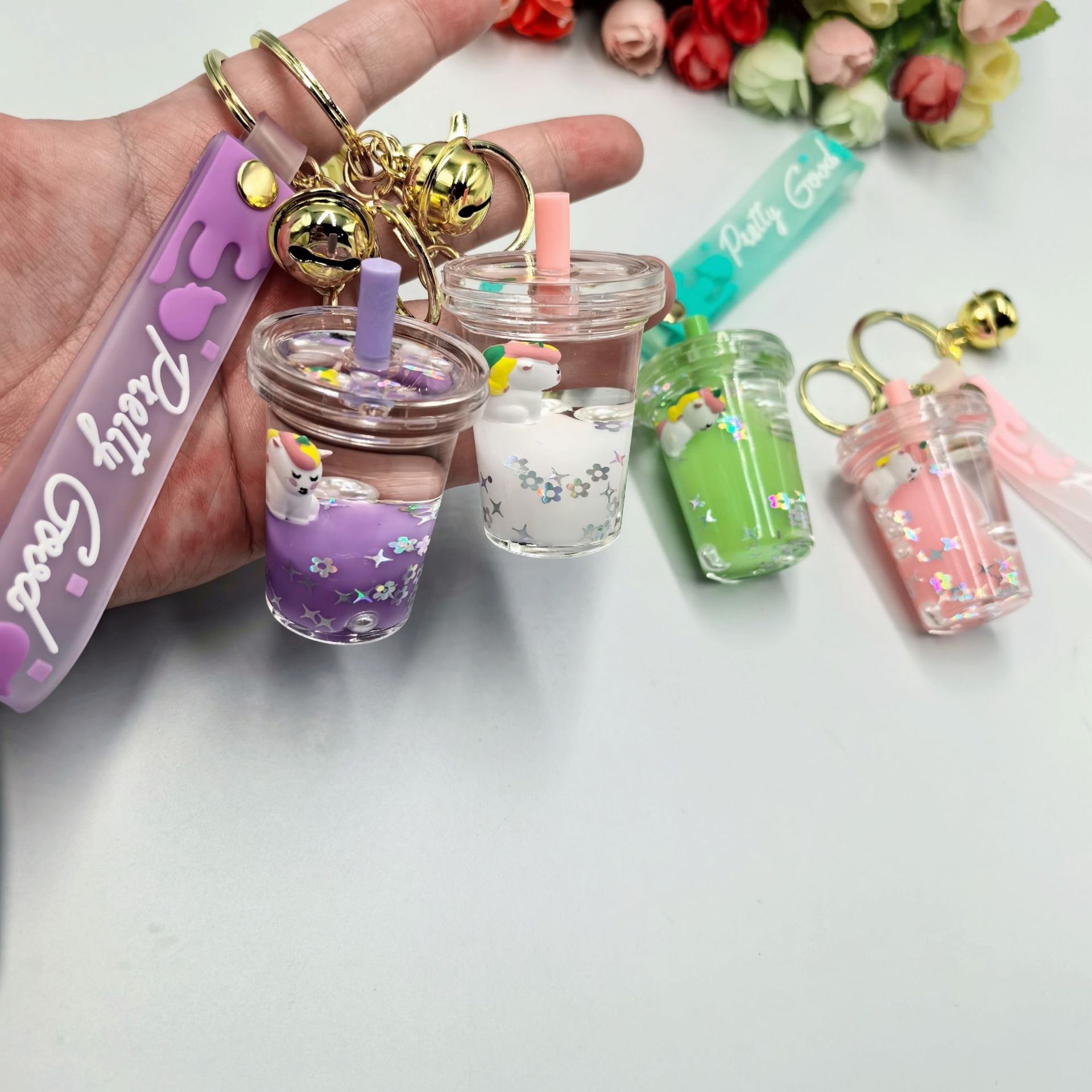Aceite flotante unicornio leche de flujo taza de té llavero colgante boutique bolsos colgante regalo creativo