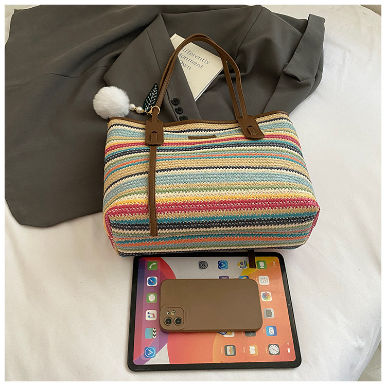 This is a new 2025 summer beach-style women's bag with a simple and versatile hand-held design. It's a single-shoulder vacation woven bag undefined