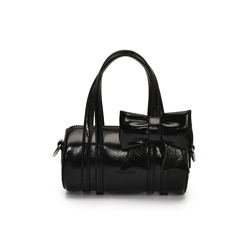 Bolso cilíndrico para niña de color sólido simple bolso de bebé con lazo dulce y lindo 2025 moda mini bolso para niños