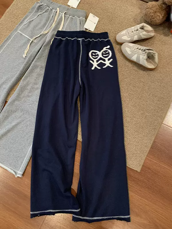 Embroidered stick figure design, with visible stitching and raw hem, women's loose-fitting wide-leg straight-cut casual pants, flowing fabric, slimming effect, long p