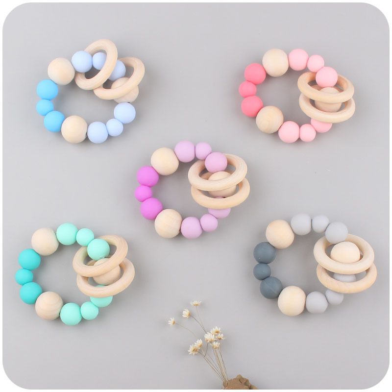 Suministros para bebés pulsera de silicona molar de juguete para niños Cadena de cochecito de dinosaurio de tres piezas creativa pequeña campana colgante