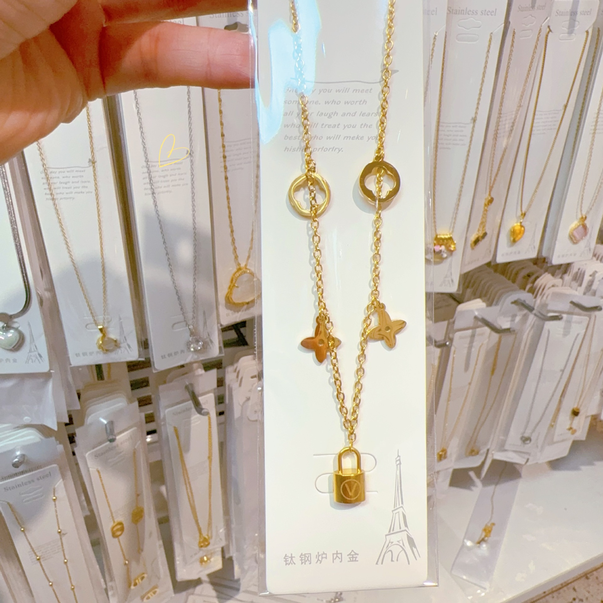 Golden necklace with letters, letter V