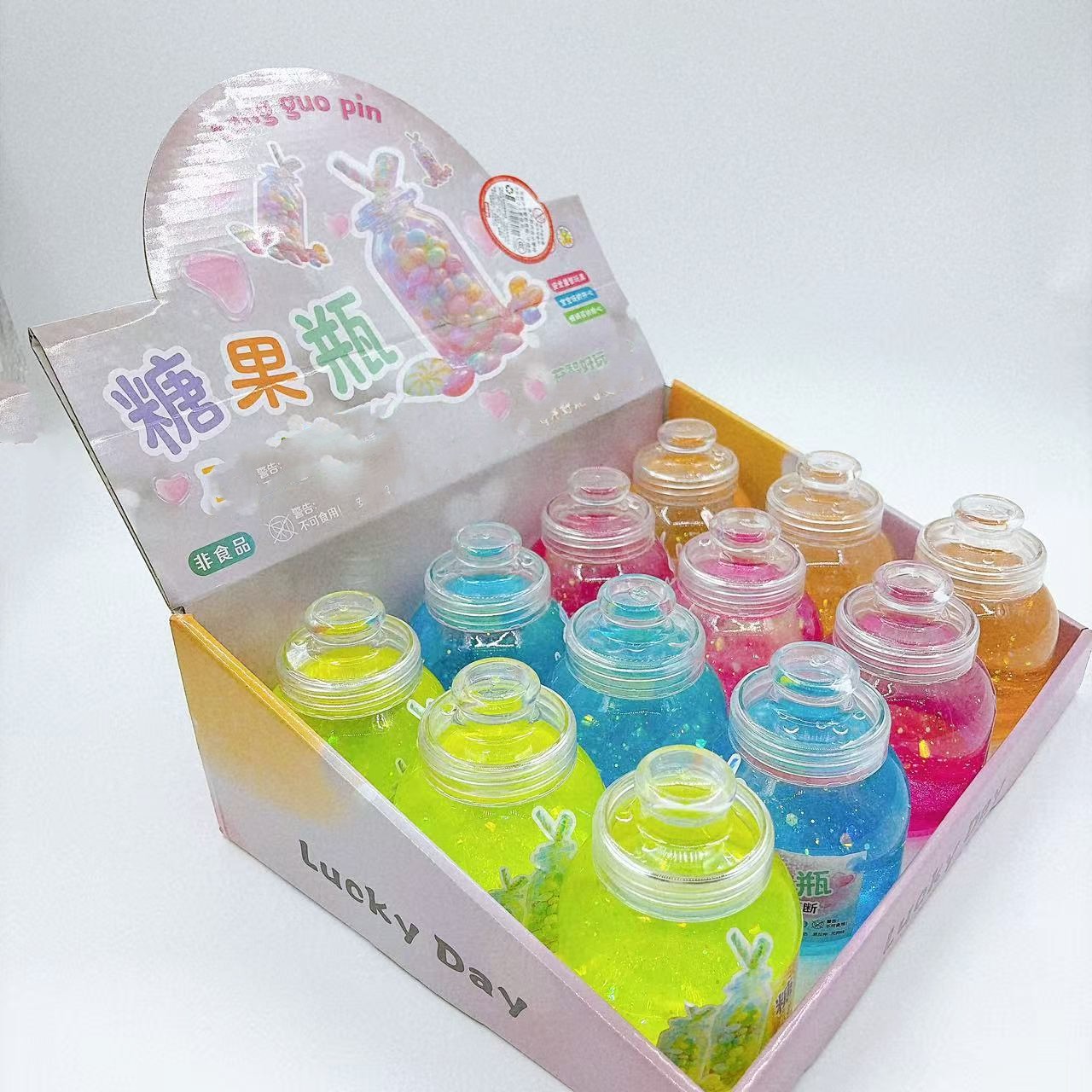 Botella de dulces de barro de cristal colorido botella de barro colorido juguetes para niños goma espumante slime barro transparente al por mayor