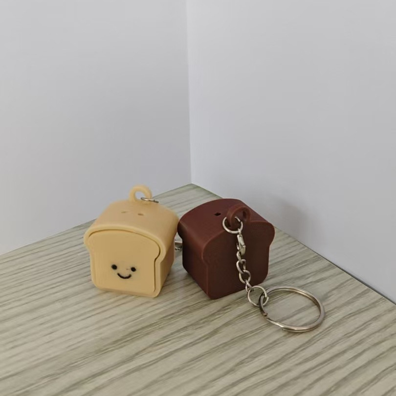 Nuevos productos transfronterizos de pan tostado llave de botón de impresión 3D creativa extraña artefacto de reducción de presión colgante de bolsa multifuncional