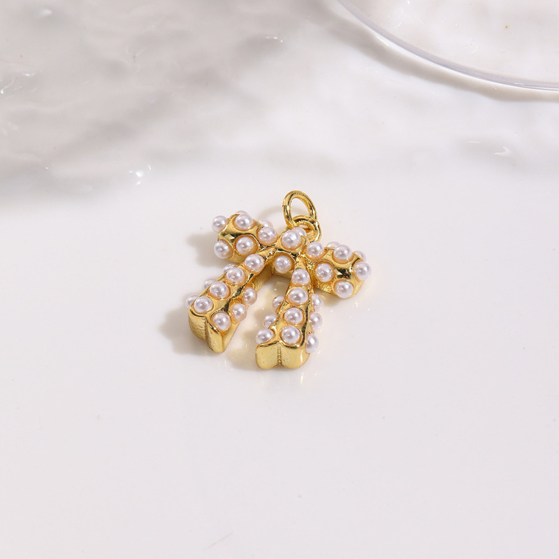 ヨーロッパとアメリカのファッショナブルな銅メッキ 18K 象嵌模造パールリボンネックレスペンダントイヤリング 3 点セット装飾|undefined