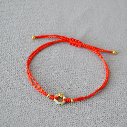 A unique, minimalist Chinese-style zodiac red rope braided Qinglong jade pendant bracelet with a circular clasp for adjustable closure, exuding elegance and personality.