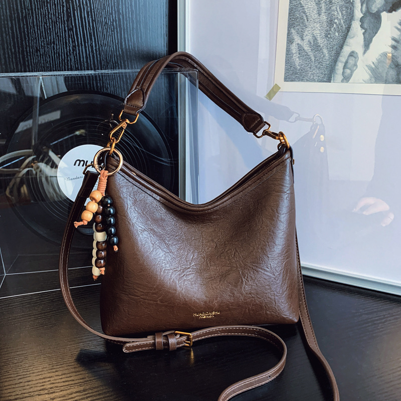 Nicho de alta sensación bolso de cuero suave para mujeres 2025 nueva moda versátil mochila de hombro mochila de viaje