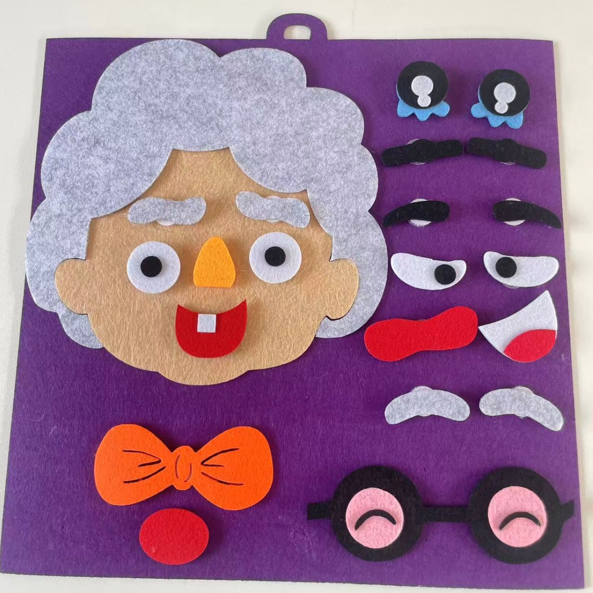 Jardín de infantes educación temprana para niños expresión facial rompecabezas fieltro tela no tejida material de mano bolsa de juguetes de educación temprana