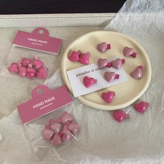 Sweet heart-shaped hair clip in pink peach color scheme, Instagram style, cute mini bangs clip with frayed edges