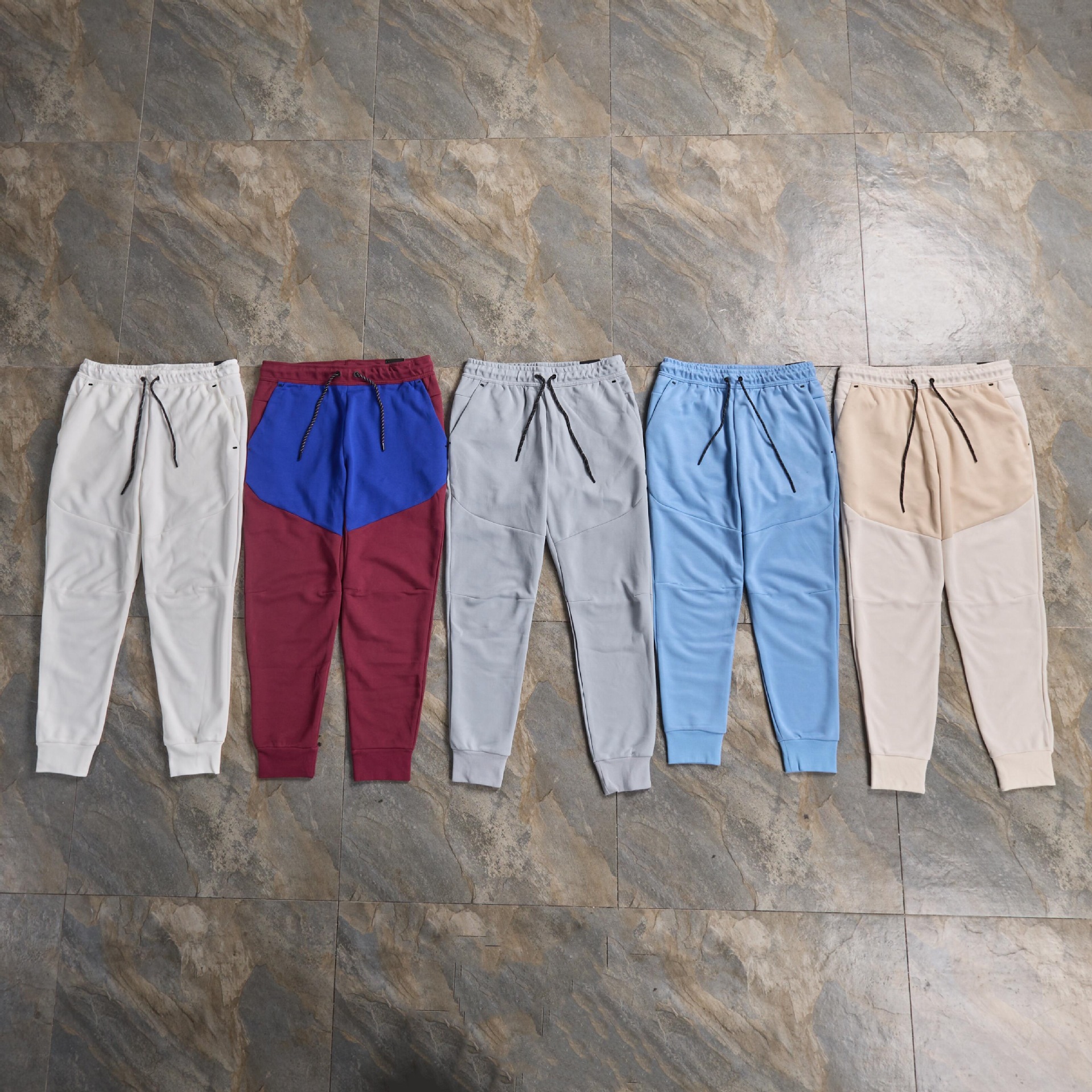 Pantalones casuales deportivos primavera y otoño aire laminado de algodón con cremallera pantalones deportivos para hombres y mujeres
