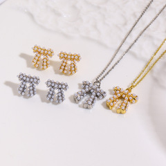 ヨーロッパとアメリカのファッショナブルな銅メッキ 18K 象嵌模造パールリボンネックレスペンダントイヤリング 3 点セット装飾