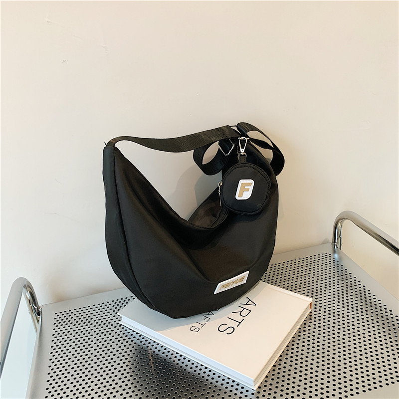 Bolsa de bolinillos de gran capacidad 2025, primavera nueva bolsa de viaje, bolsas de hombro inclinadas para estudiantes universitarios.