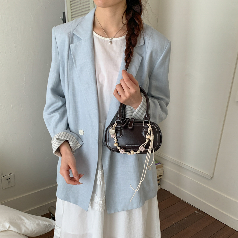 Bolsa de hombro coreana de diseño de nicho simple 2026 nueva moda femenina de tendencia diaria textura de viaje popular bolso de hombro