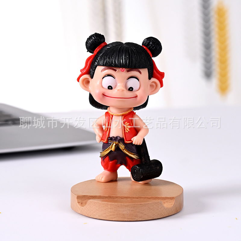 La celebridad de Internet Nezha's Devil Boy Naohai, el soporte para teléfono móvil que rodea el mundo, el soporte para teléfono móvil de madera Nezha Lingzhu, decoración de escritorio