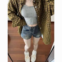 ギャルは古いデニムのショートパンツをしています。