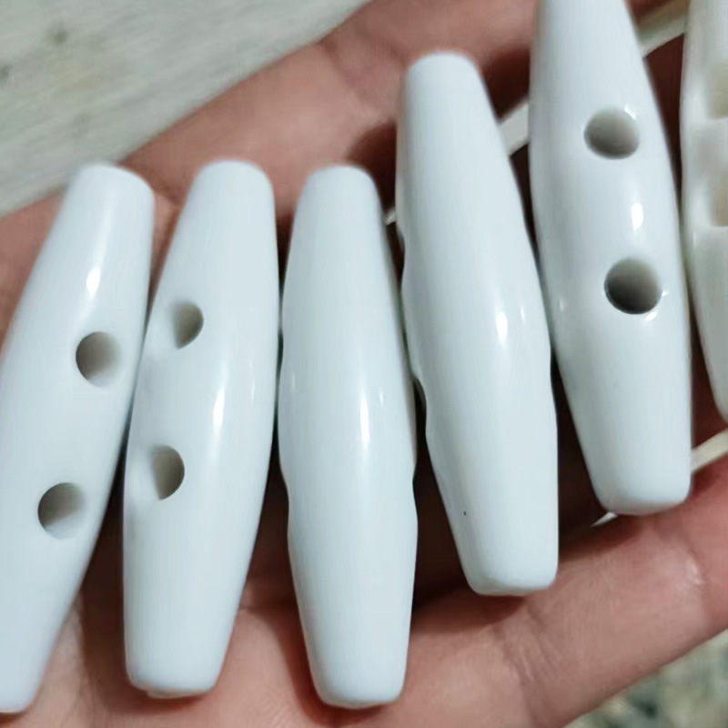 现货塑料两眼皮衣外套橄榄扣黑色凸花毛呢大衣纽风衣塑料钮扣批发