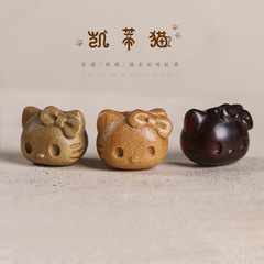 Carving a cute cartoon cat head from sandalwood, with holes for making phone/bag pendants, a charming cat accessory