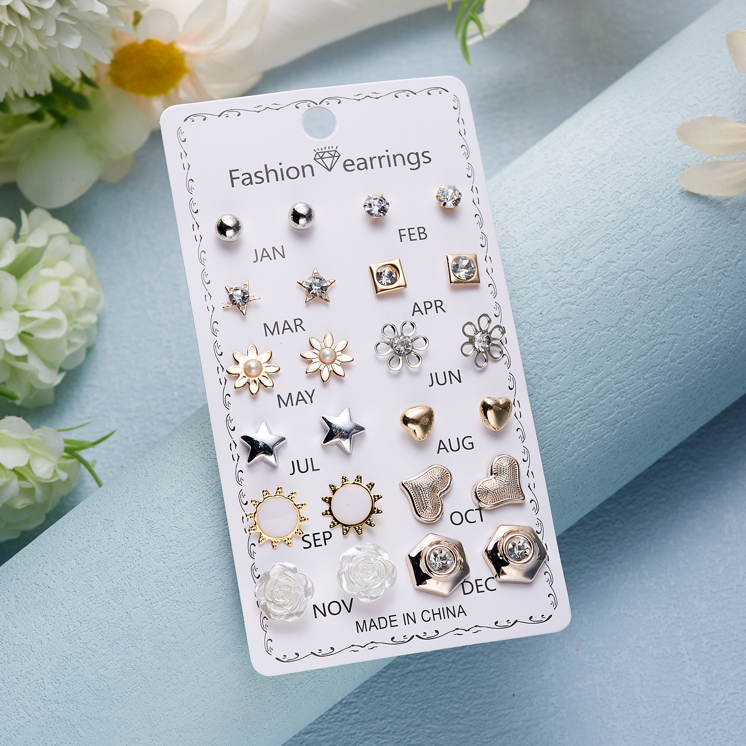 Set de 12 pares de aretes con flores de diamante
