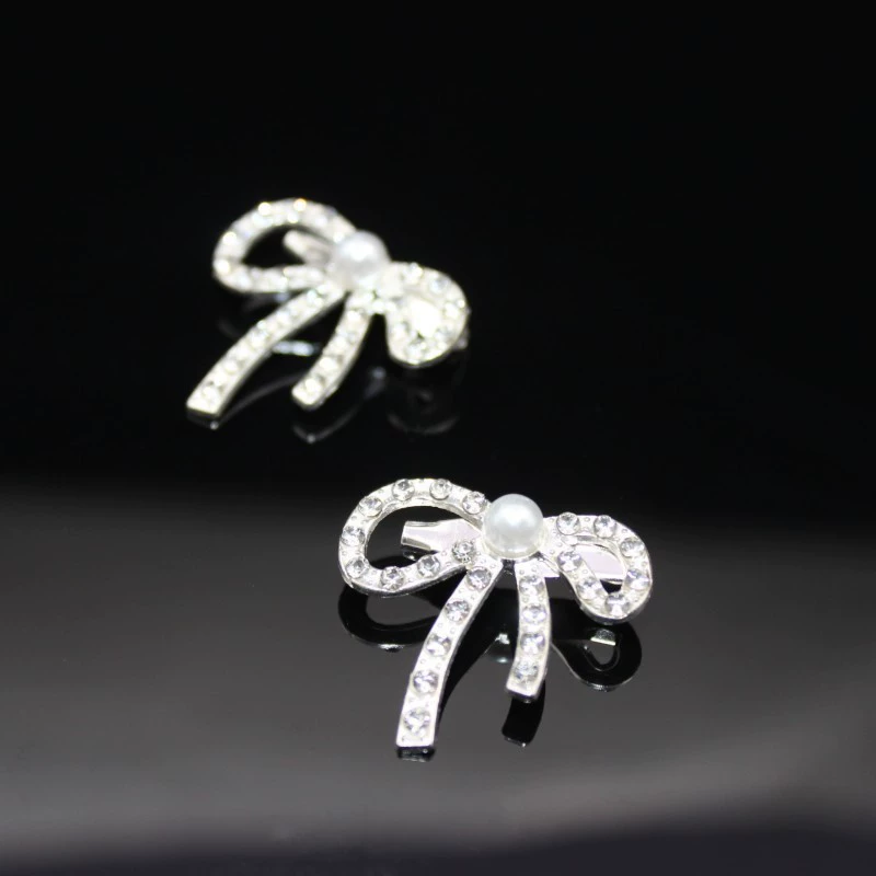Metal brooch from pearl with bow